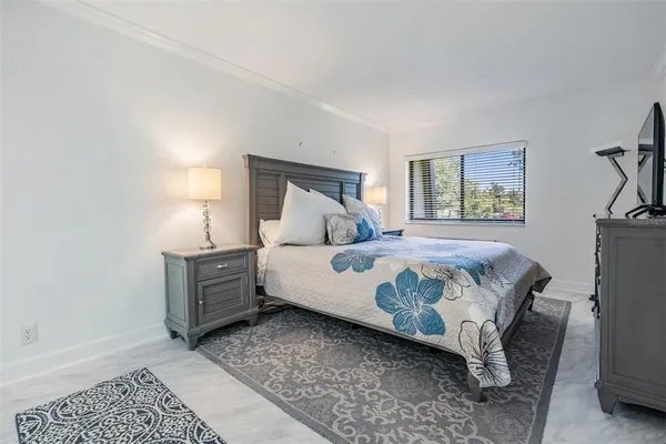 a bedroom with a bed and a mirror