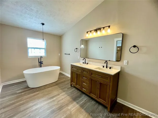 a bathroom with a double vanity sink and a mirror