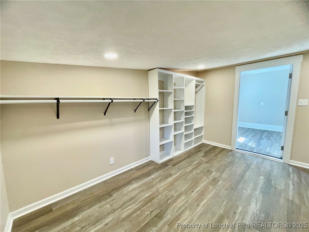 416 Old Maxton Road Raeford, NC 28376 - Photo 18 of 26 an empty room with wooden floor closet and windows