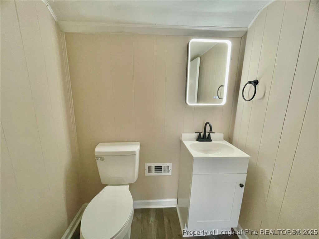 416 Old Maxton Road Raeford, NC 28376 - Photo 25 of 26 a bathroom with a toilet a sink and mirror