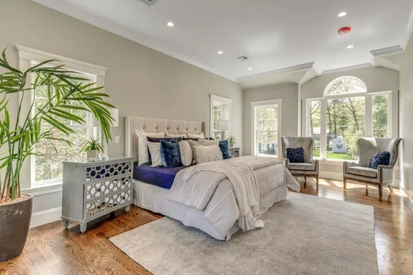 a spacious bedroom with a bed and a large window