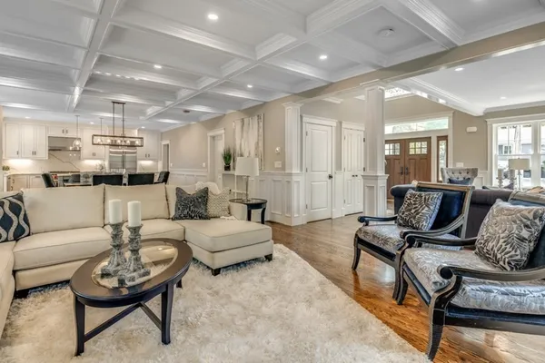 a living room with furniture and a view of kitchen