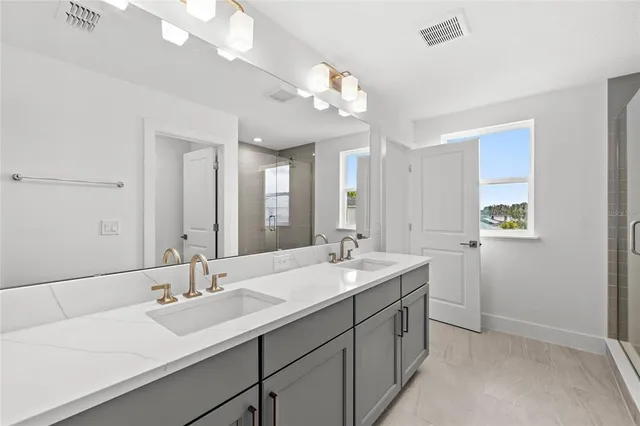 a bathroom with a double vanity sink and a mirror
