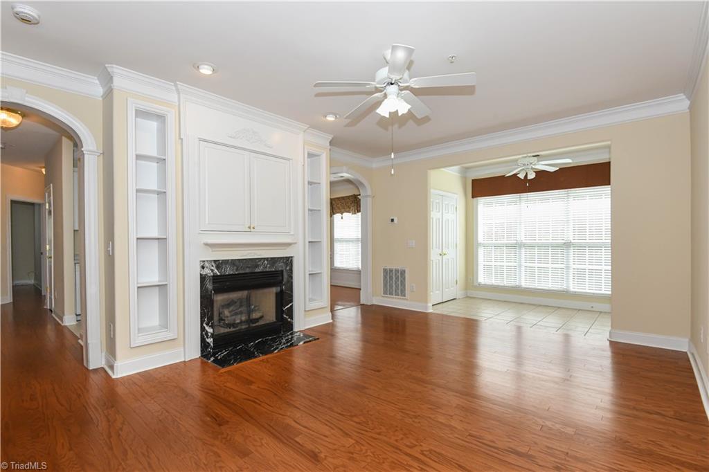 522 College Road Greensboro, NC 27410 - Photo 11 of 36 Another view of the living room and sunroom - Take note of the arched doorways.