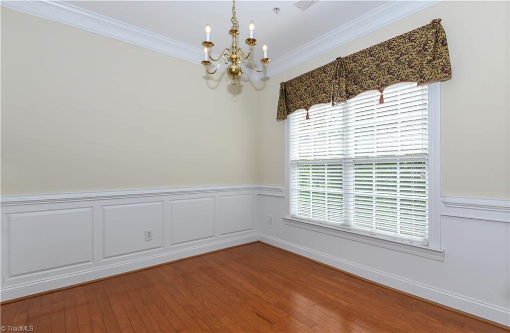 522 College Road Greensboro, NC 27410 - Photo 14 of 36 Another picture of the dining room - take note of the wainscoting and the wide crown molding.