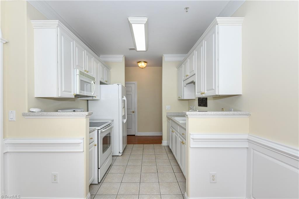 522 College Road Greensboro, NC 27410 - Photo 15 of 36 Compact kitchen with standard appliances.