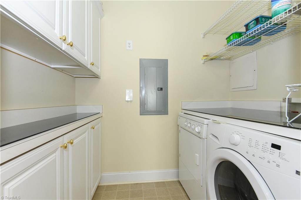 522 College Road Greensboro, NC 27410 - Photo 17 of 36 Wow - a laundry room with counter space and upper and lower cabinets.