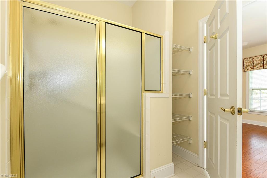 522 College Road Greensboro, NC 27410 - Photo 22 of 36 Primary Bath - shower and towel shelves