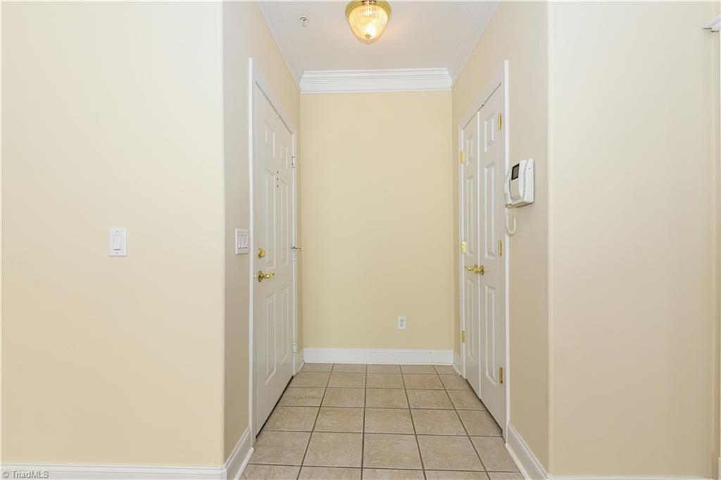 522 College Road Greensboro, NC 27410 - Photo 9 of 36 Tile flooring in the entry - take note of the heavy crown molding