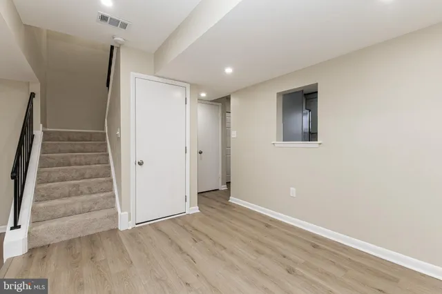 a view of an entryway with wooden floor