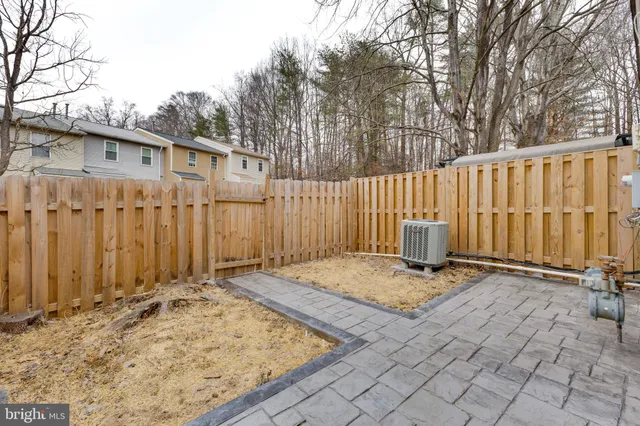 a backyard of a house with wooden fence