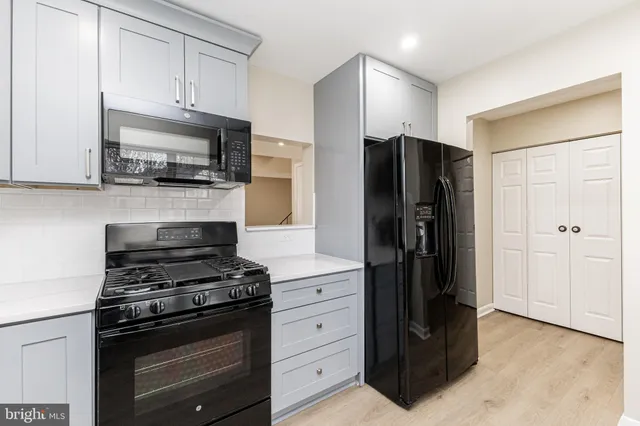 a kitchen with a refrigerator stove and cabinets