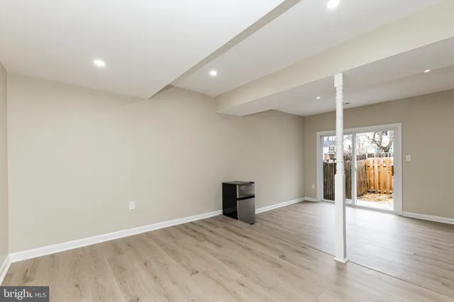 a view of a room with wooden floor