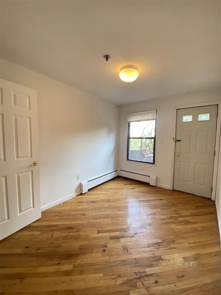 409 1st Street, Unit A Hoboken, NJ 07030 - Photo 5 of 10 a view of an empty room and window
