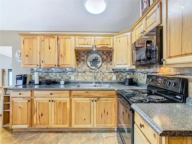 a kitchen with stainless steel appliances granite countertop a stove and a sink
