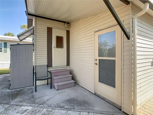 a view of a patio with table and chairs and potted plants