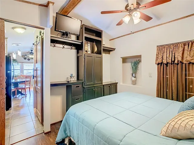 a bedroom with a bed and a chandelier