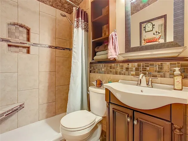 a bathroom with a sink a toilet and a shower