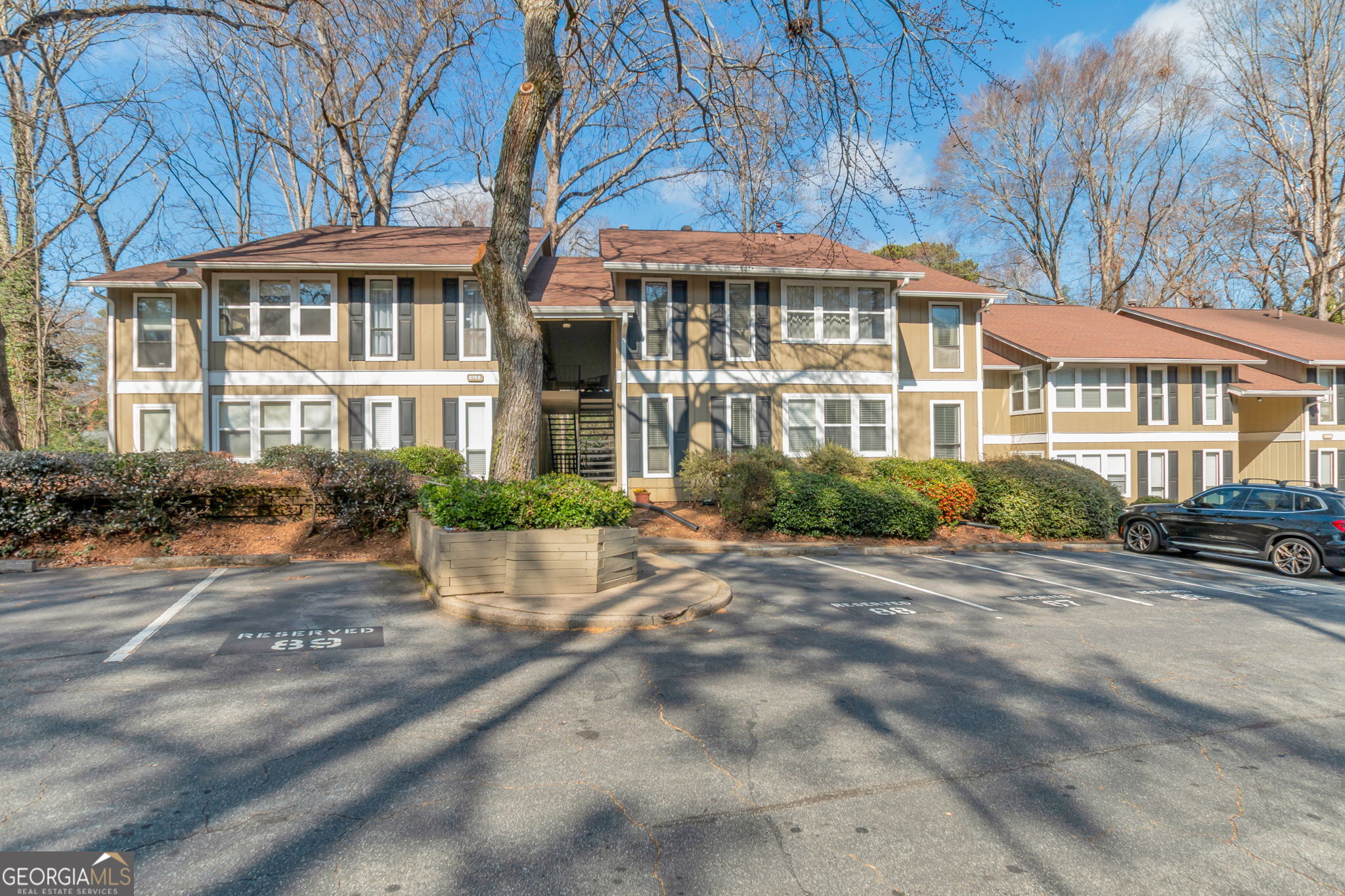 5155 Roswell Road, Unit 9 Atlanta, GA 30342 - Photo 1 of 20 a front view of a residential apartment building with a yard