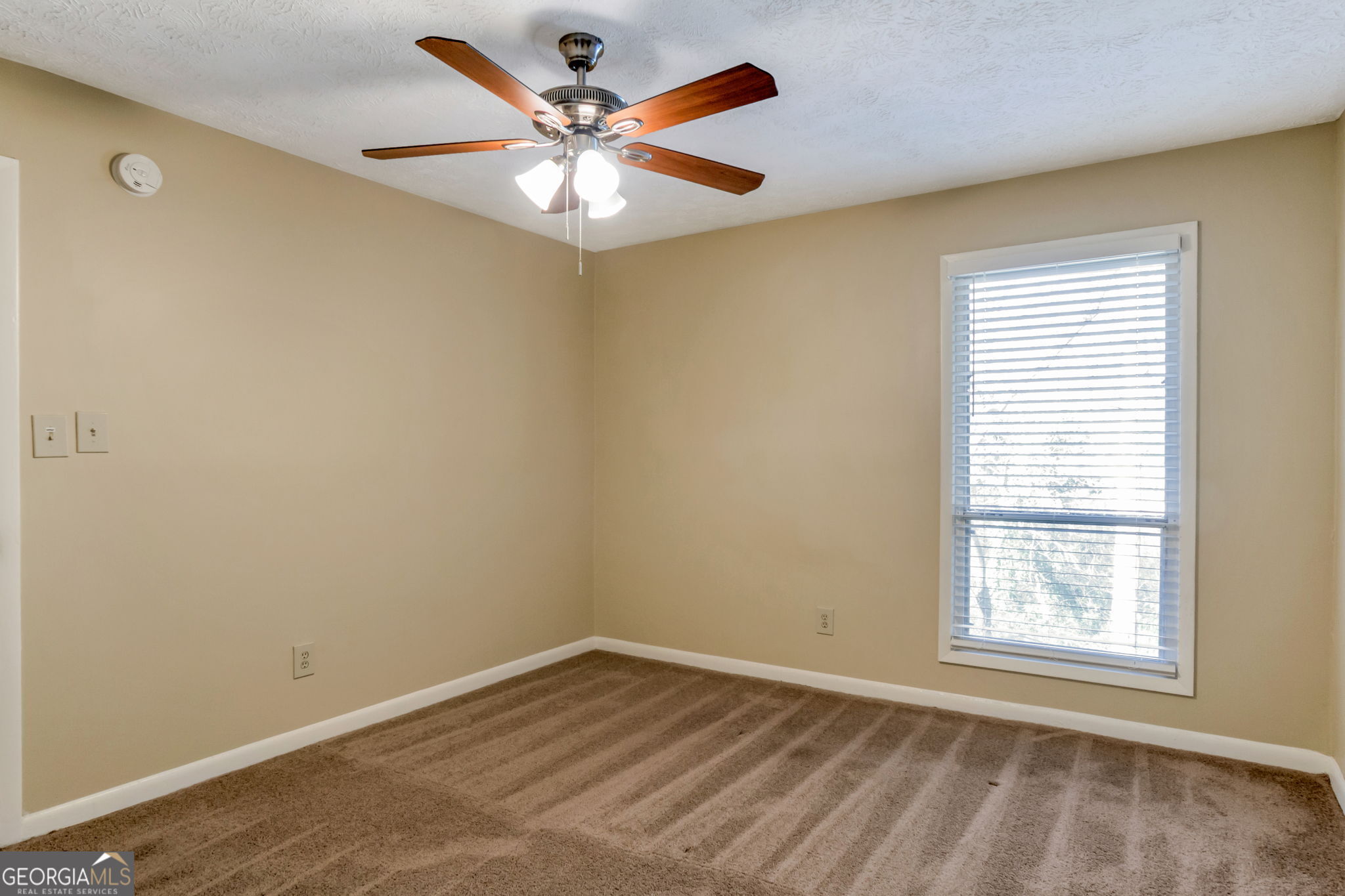 5155 Roswell Road, Unit 9 Atlanta, GA 30342 - Photo 16 of 20 an empty room with a window and a fan