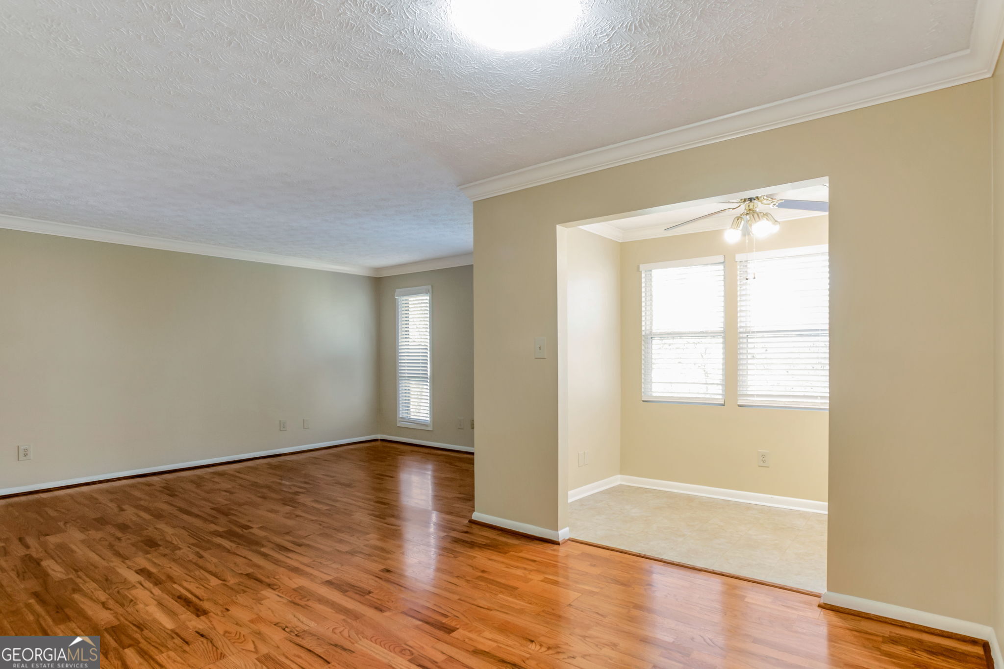 5155 Roswell Road, Unit 9 Atlanta, GA 30342 - Photo 7 of 20 a view of an empty room with wooden floor and a window