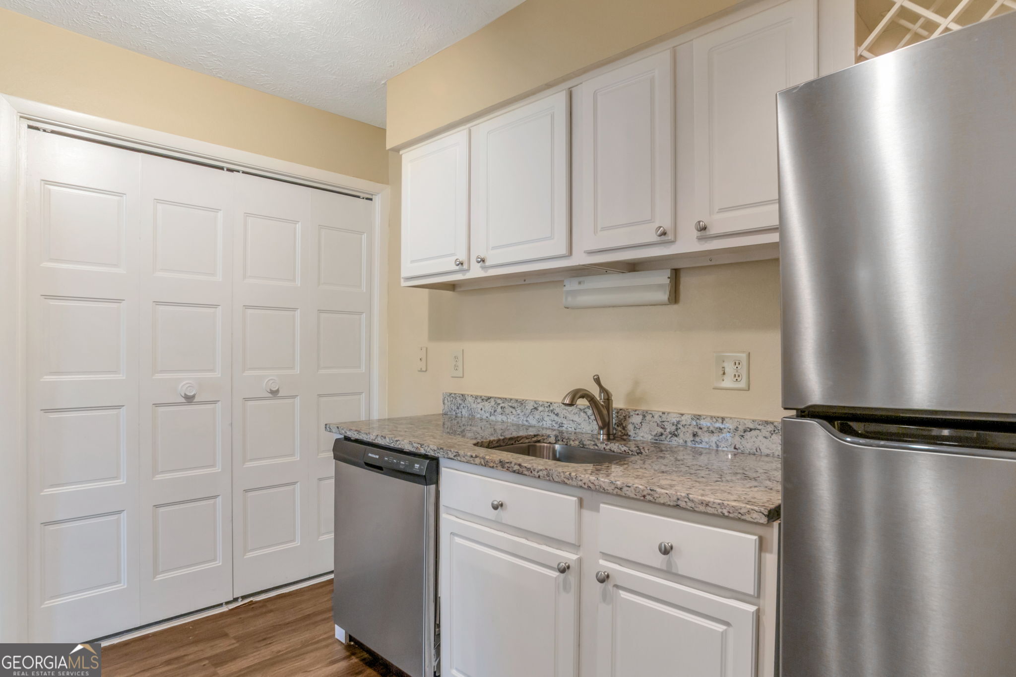 5155 Roswell Road, Unit 9 Atlanta, GA 30342 - Photo 10 of 20 a bathroom with a granite countertop sink and cabinets
