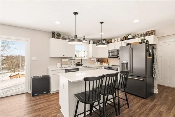 a kitchen with stainless steel appliances a stove a sink dishwasher and a refrigerator