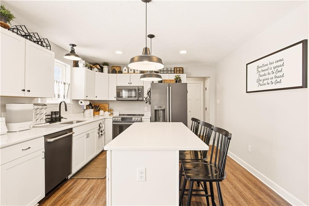 3106 Upper Ridgeview Road Connellsville, PA 15425 - Photo 13 of 44 a kitchen with kitchen island a stove a table and chairs in it