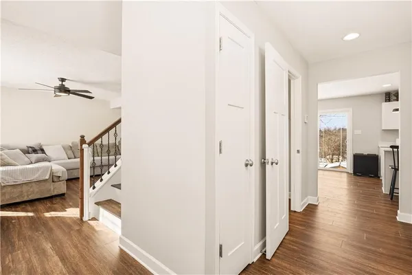a view of a livingroom with wooden floor and staircase