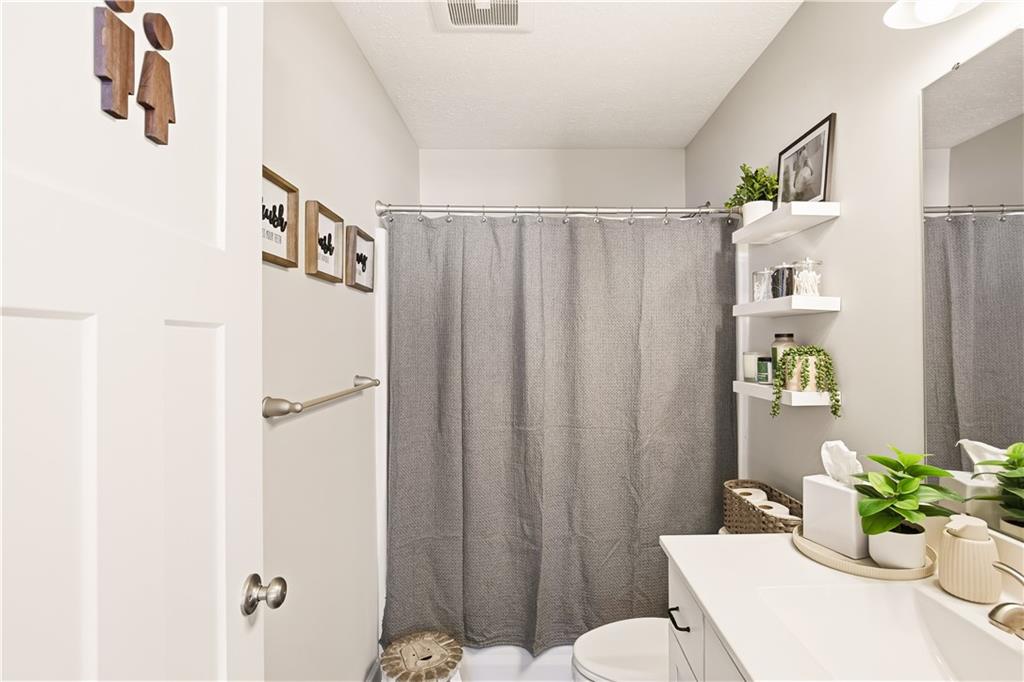 3106 Upper Ridgeview Road Connellsville, PA 15425 - Photo 25 of 44 a bathroom with a sink a toilet and shower curtain
