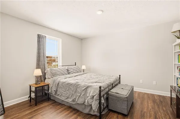 a bedroom with a bed and a book shelf