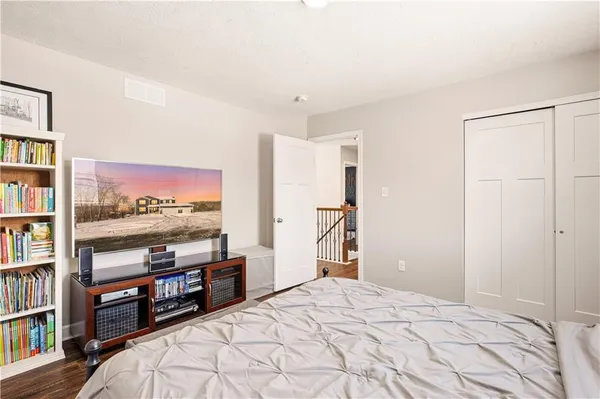 a bedroom with a large bed and a tv