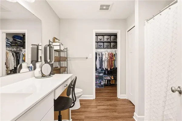 a bathroom with a sink a toilet a mirror and vanity