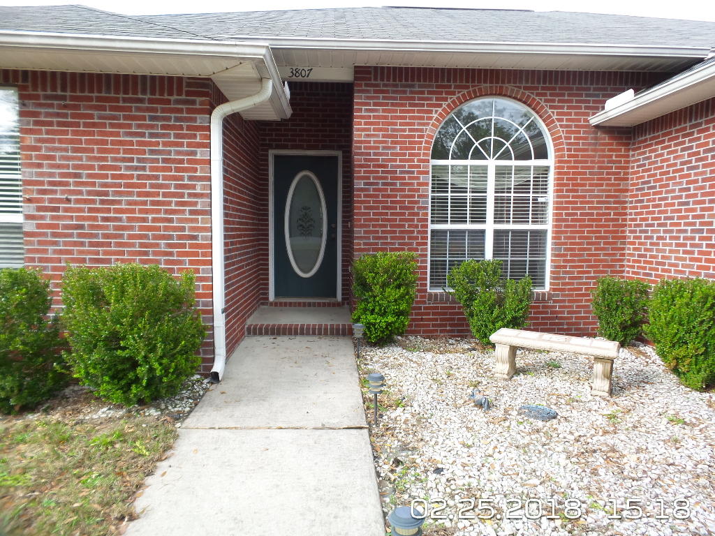 3807 Poverty Creek Road Crestview, FL 32539 - Photo 1 of 27 a front view of a house with garden