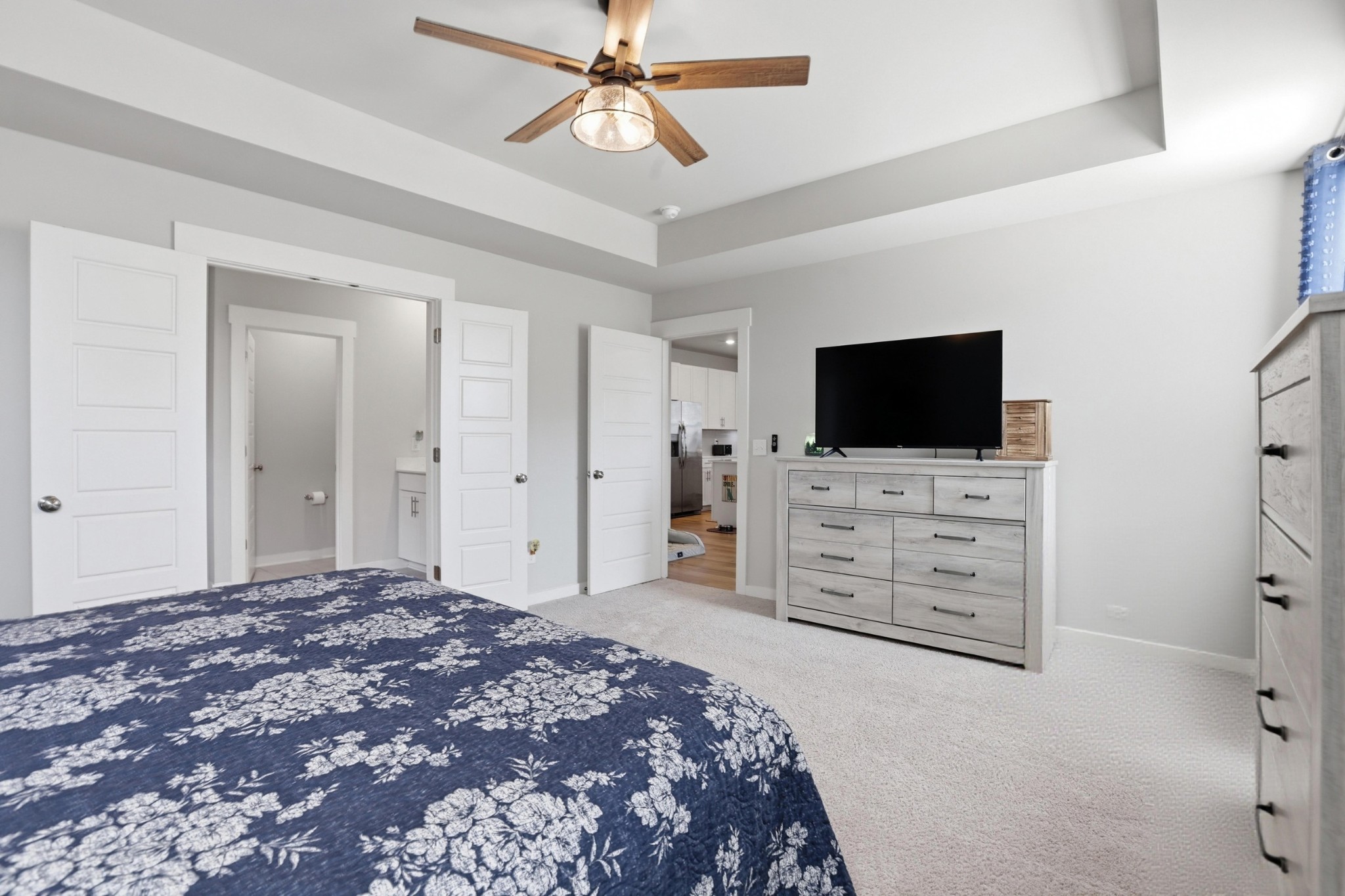 129 Merion Way Lebanon, TN 37087 - Photo 11 of 38 a bedroom with a bed and a flat tv screen on dresser
