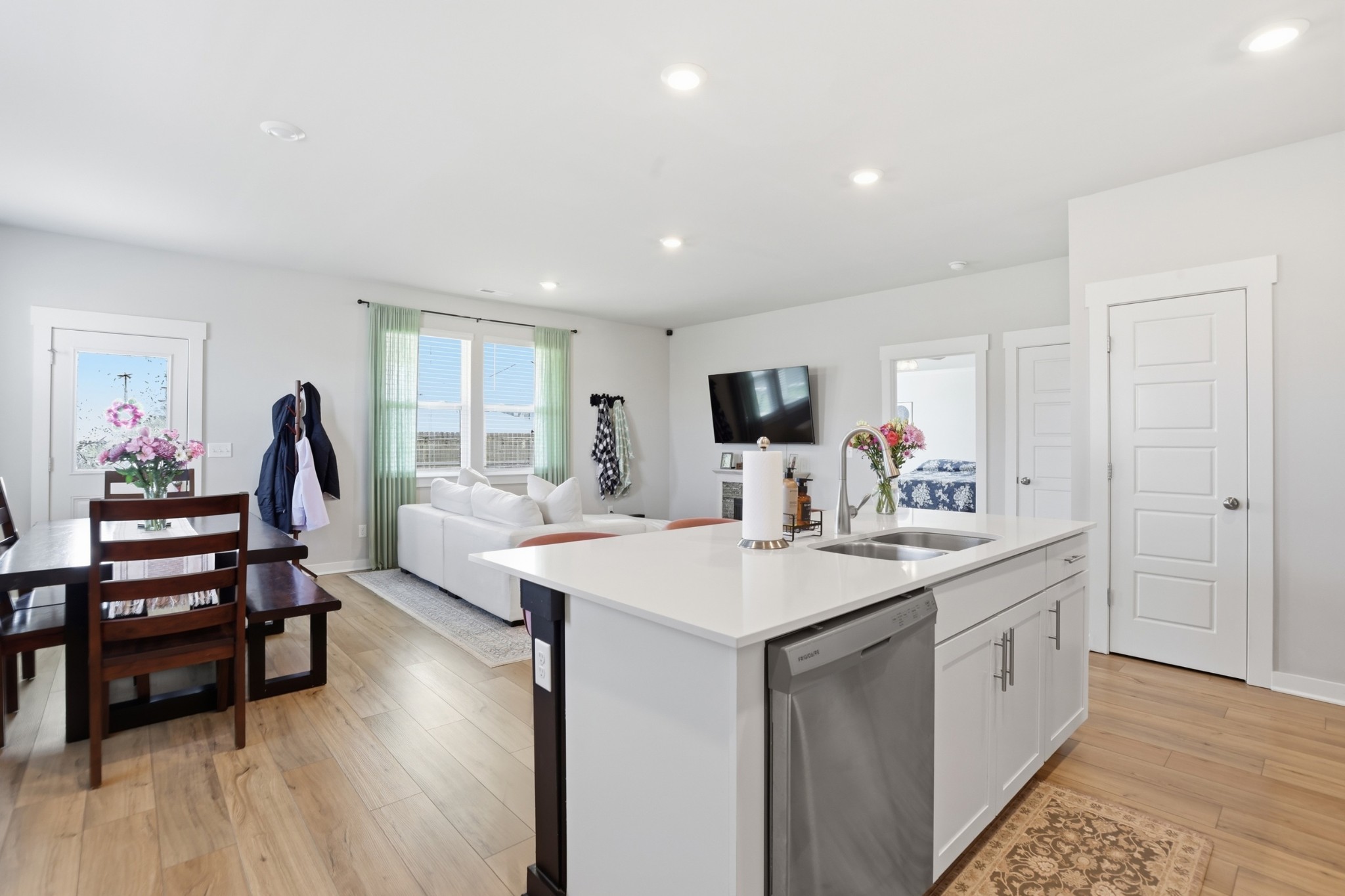 129 Merion Way Lebanon, TN 37087 - Photo 7 of 38 a view of kitchen island sink refrigerator and wooden floor