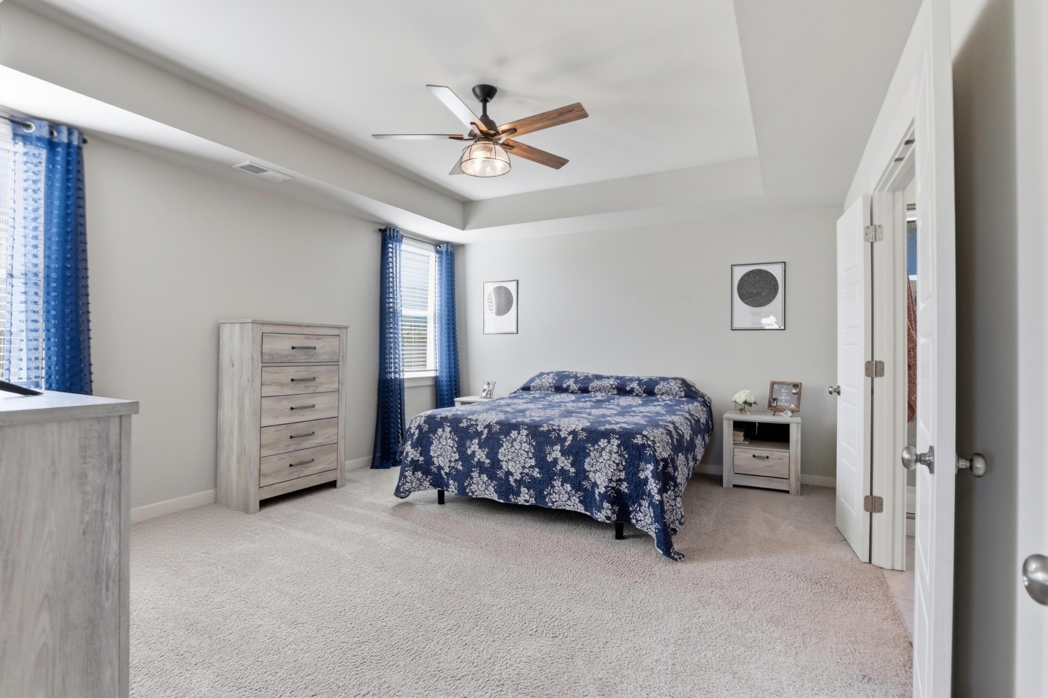 129 Merion Way Lebanon, TN 37087 - Photo 10 of 38 a bedroom with a bed a dresser and a chandelier