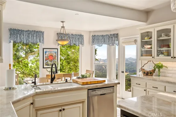 a kitchen with stainless steel appliances granite countertop a sink and a window