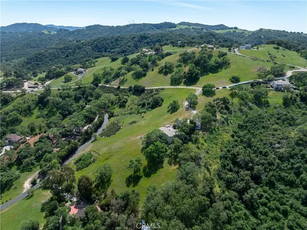 an aerial view of a houses with a yard