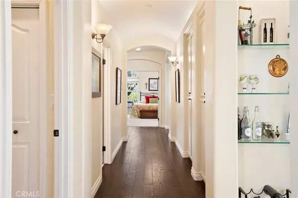 a view of a hallway with wooden shelves