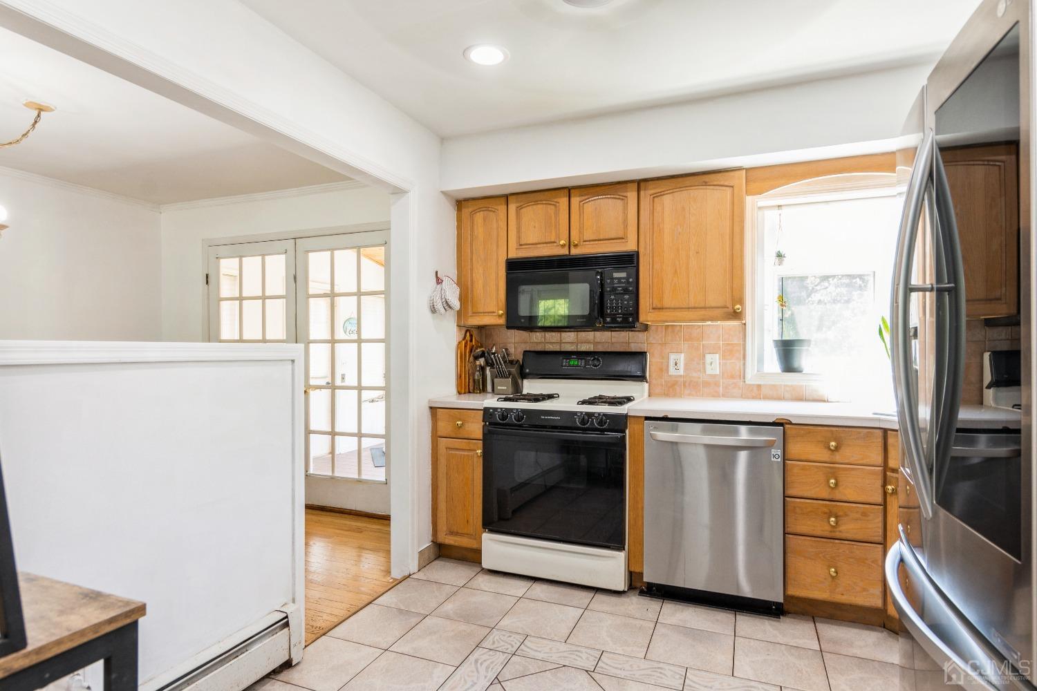 141 Overbrook Road Piscataway, NJ 08854 - Photo 16 of 38 a kitchen with stainless steel appliances a stove sink and microwave