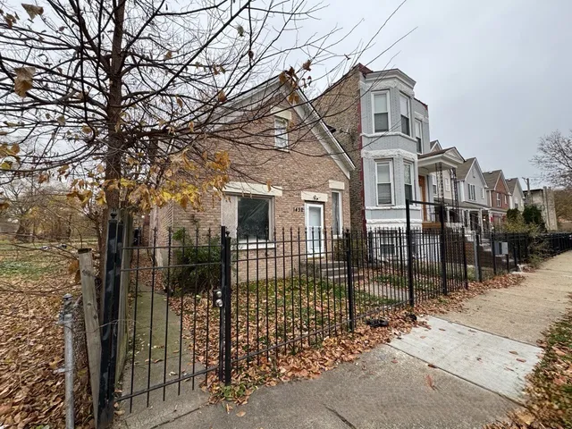 a view of a brick house with large windows