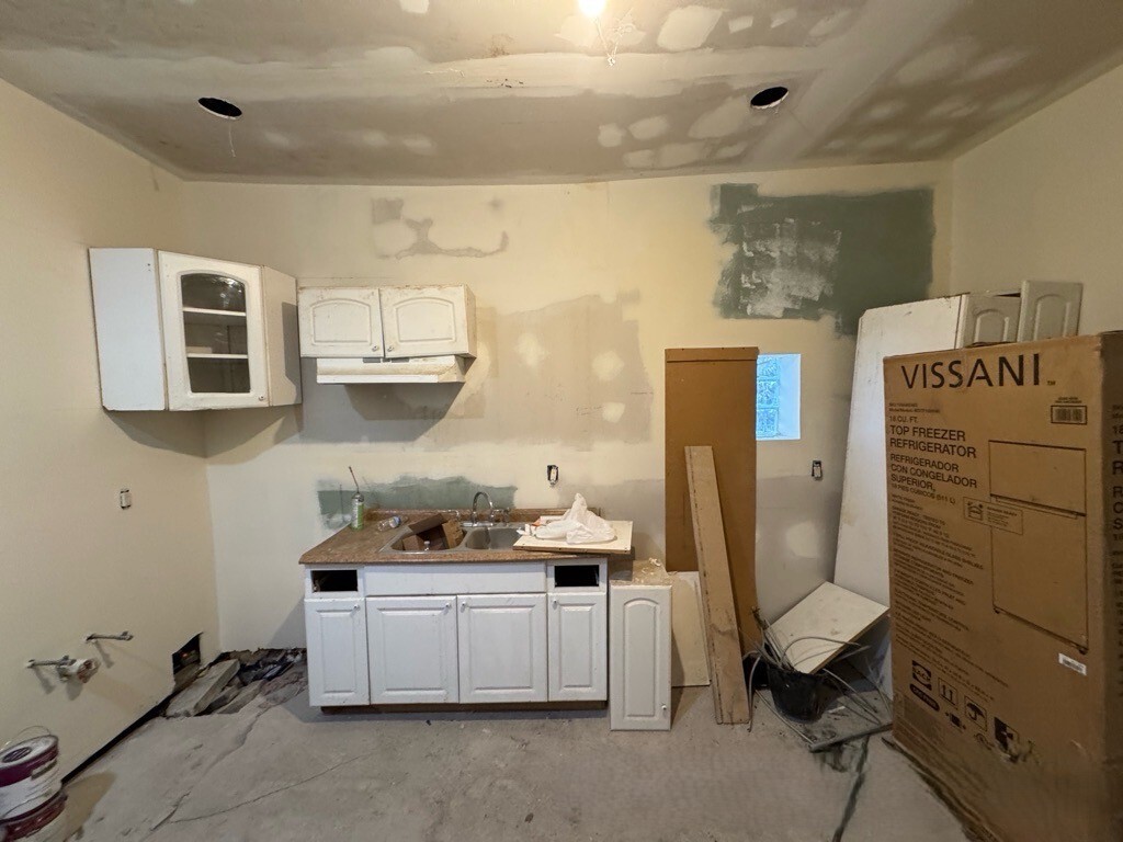 1432 South Harding Avenue Chicago, IL 60623 - Photo 4 of 11 a kitchen with a refrigerator and cabinets