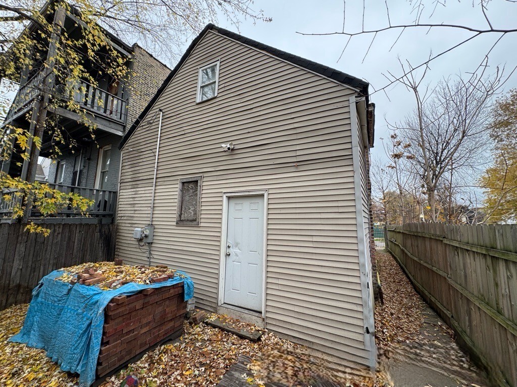 1432 South Harding Avenue Chicago, IL 60623 - Photo 9 of 11 a house view with a backyard space