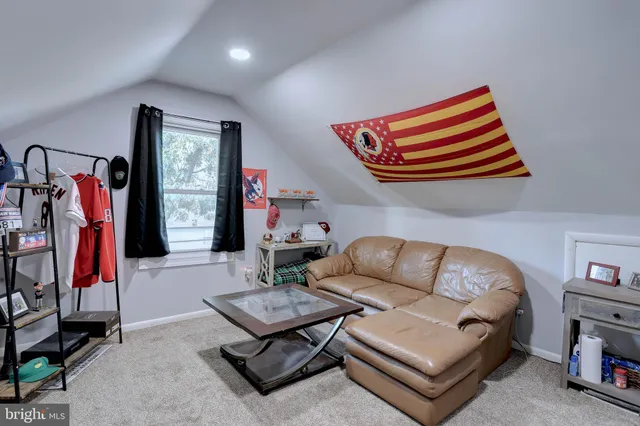 a living room with furniture and a ceiling fan