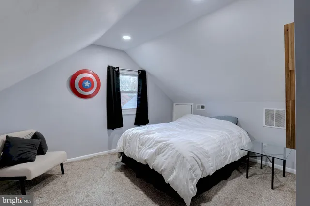 a spacious bedroom with a bed and a couch