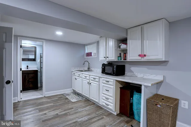 a kitchen with stainless steel appliances a sink stove and cabinets