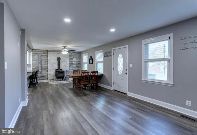 a living room with furniture and a piano