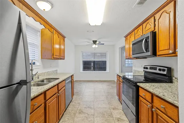 a kitchen with stainless steel appliances granite countertop a stove and a sink