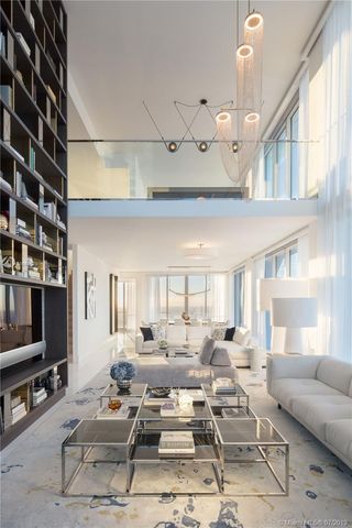a living room with furniture a rug and a flat screen tv